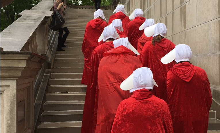 Women march up the steps of the Missouri capitol dressed as Margaret Atwood’s handmaids. CREDIT: Screenshot, @PPGreatPlains Twitter.