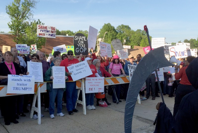 Protesters rally outside the town hall held by New Jersey Republican Rep. Tom MacArthur in Willingboro, N.J., Wednesday, May 10, 2017. CREDIT: AP Photo/Michael Catalini