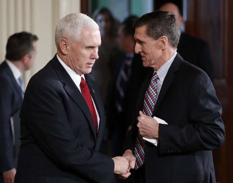 Vice President Mike Pence and National Security Adviser Michael Flynn, right, shake hands before the start of the President Donald Trump and Japanese Prime Minister Shinzo Abe joint new conference in the East Room of the White House, in Washington, Friday, Feb. 10, 2017. CREDIT: AP Photo/Carolyn Kaster