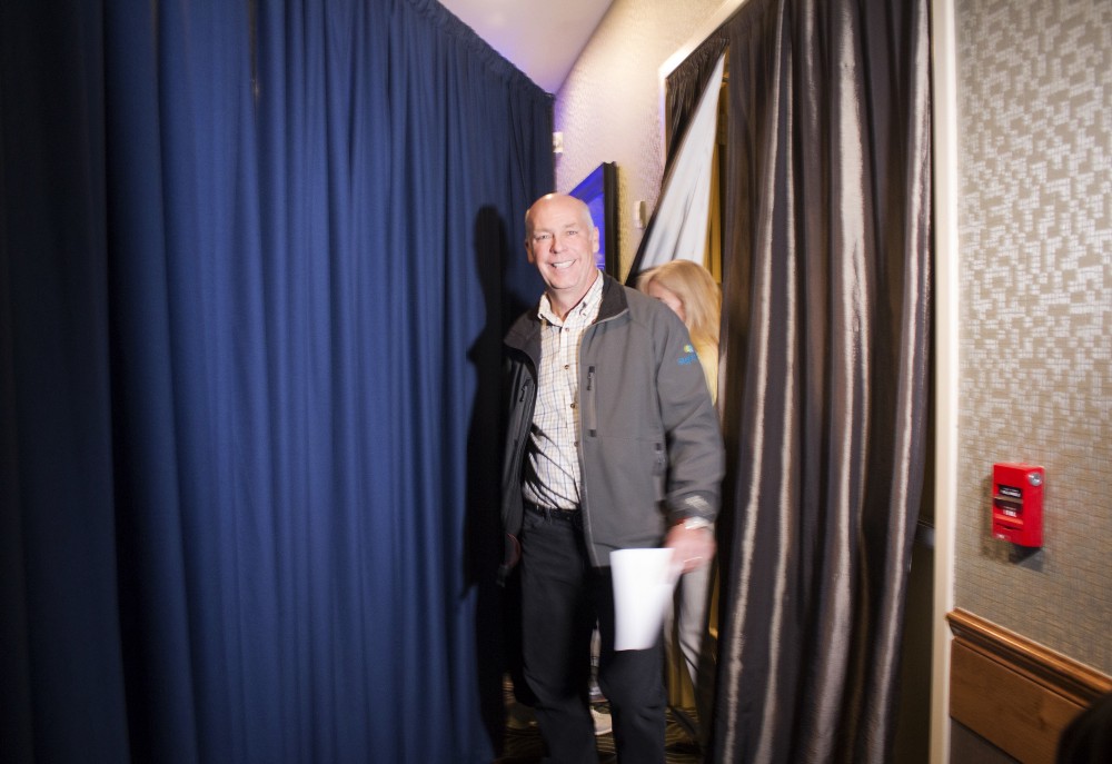 Greg Gianforte prepares to go onstage at a hotel ballroom in Bozeman to thank supporters after winning Montana’s sole congressional seat on Thursday. In his speech, Gianforte apologized for a altercation at his campaign headquarters with a reporter on the eve of the special election. The altercation led to a misdemeanor assault citation. CREDIT: AP Photo/Bobby Caina Calvan