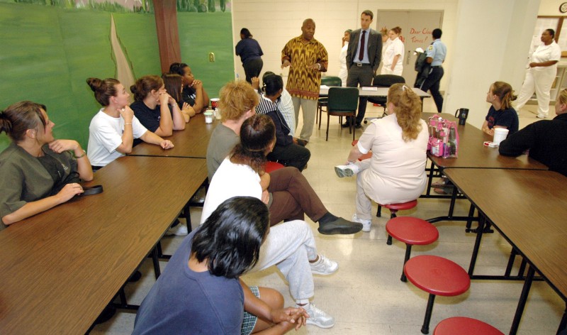 Pastor Kenneth Glasgow, gesturing in center, speaks with state inmates about registering to vote at a work-release facility in Birmingham, Ala., on Tuesday, Sept. 16, 2008. Glasgow heads a coalition that is traveling to state prisons in Alabama to register some convicted felons to vote. CREDIT: AP Photo/Jay Reeves