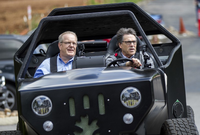 Energy Secretary Rick Perry, seen here driving a 3-D printed vehicle at Oak Ridge National Laboratory in Knoxville, Tennessee on May 22, is under pressure to release ARPA-E grant funding. CREDIT: AP Photo/Erik Schelzig