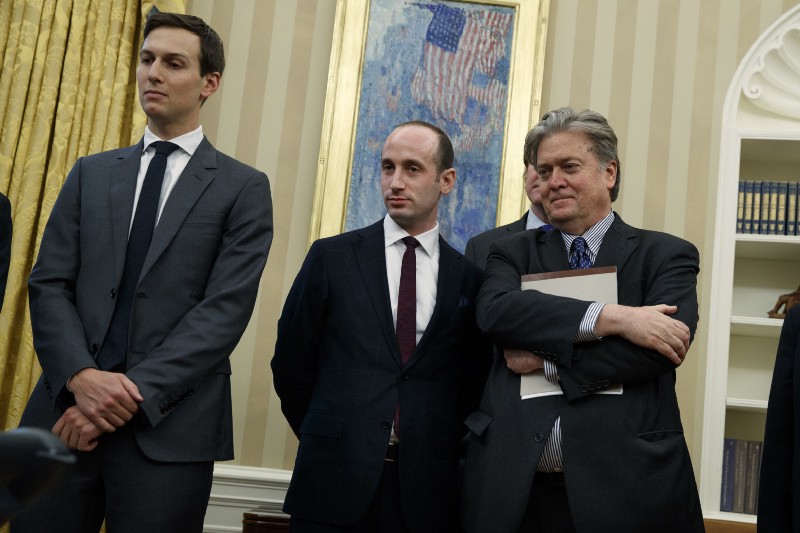 From left, Senior Adviser Jared Kushner, policy adviser Stephen Miller, and chief strategist Steve Bannon watches as President Donald Trump signs an executive order to withdraw the U.S. from the 12-nation Trans-Pacific Partnership trade pact agreed to under the Obama administration, Monday, Jan. 23, 2017, in the Oval Office of the White House in Washington. CREDIT: AP Photo/Evan Vucci