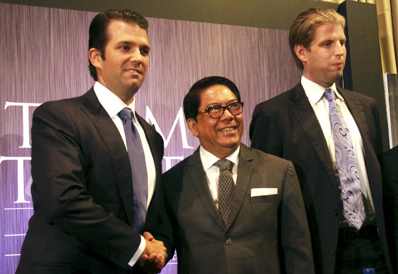 Donald Trump Jr., left, and Eric Trump, right, sons of real estate developer Donald Trump, pose with local developer Jose E. B. Antonio during a press conference on the launching of Manila’s Trump Tower project Tuesday, June 26, 2012 in the financial district of Makati, Philippines. The US$150-million, 56-story residential building using the brand name and mark under license from the New York-based Trump will be constructed by a local construction company. CREDIT: AP Photo/Pat Roque