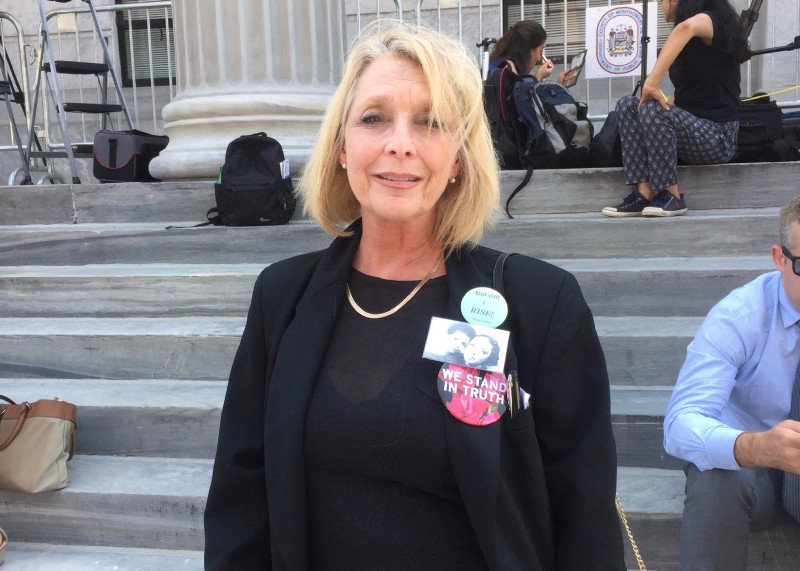 Victoria Valentino stands on the steps of the Montgomery County Courthouse during the second day of jury deliberations in the trial of Bill Cosby on June 13, 2017. CREDIT: Jessica Goldstein