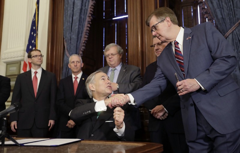 Gov. Greg Abbott, center, shakes hands with Lt. Gov. Dan Patrick at the Texas Capitol in Austin, May 25, 2017. CREDIT: AP Photo/Eric Gay