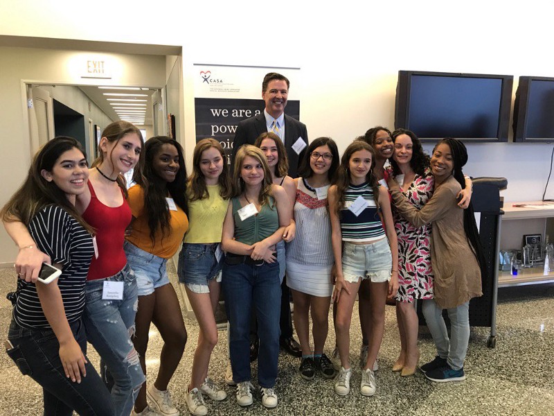 James Comey with some of the kids who’ve benefited from CASA’s services. CREDIT: Maggie Haberman/Twitter