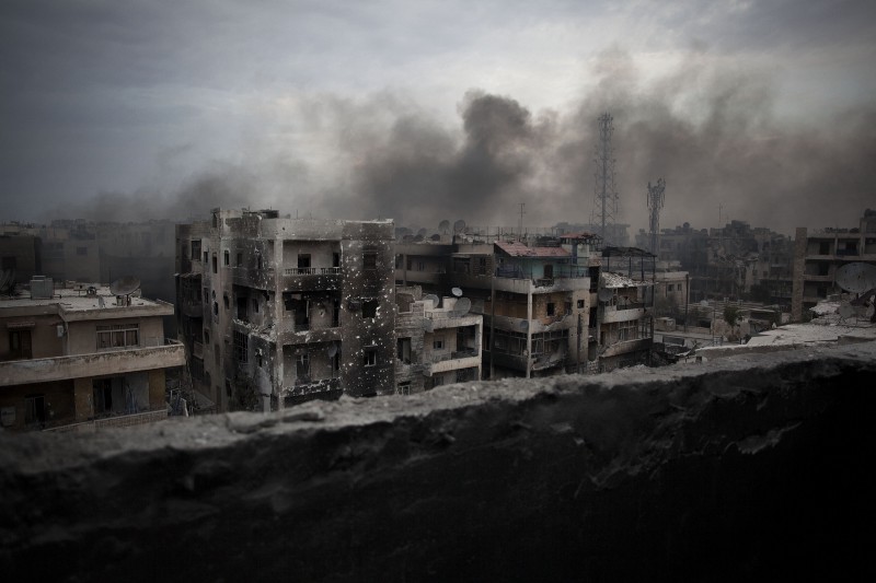 Smoke rises over Saif Al Dawla district, in Aleppo, Syria. CREDIT: AP Photo/ Manu Brabo, File