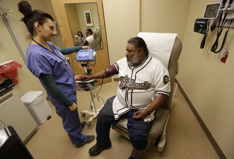 Medical assistant takes blood pressure of patient in Salt Lake City, Utah health clinic. CREDIT: AP Images