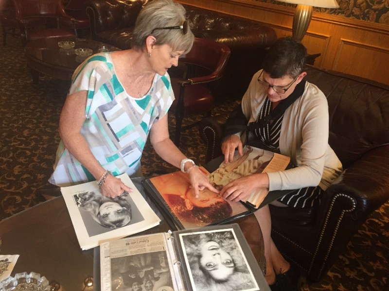 Heidi Thomas, left, and Beth Ferrier look through old modeling photos at the Brown Palace Hotel and Spa in Denver, Co. CREDIT: Jessica Goldstein
