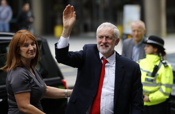 Britain’s Labour party leader Jeremy Corbyn waves as he arrives at Labour party headquarters in London. CREDIT: AP Photo/Frank Augstein
