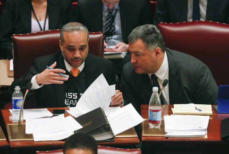 Sen. Jose Peralta, D-East Elmhurst, left, and Sen. Marc Panepinto, D-Buffalo, work in the Senate Chamber at the Capitol on Thursday, March 12, 2015, in Albany, N.Y. CREDIT: AP Photo/Mike Groll
