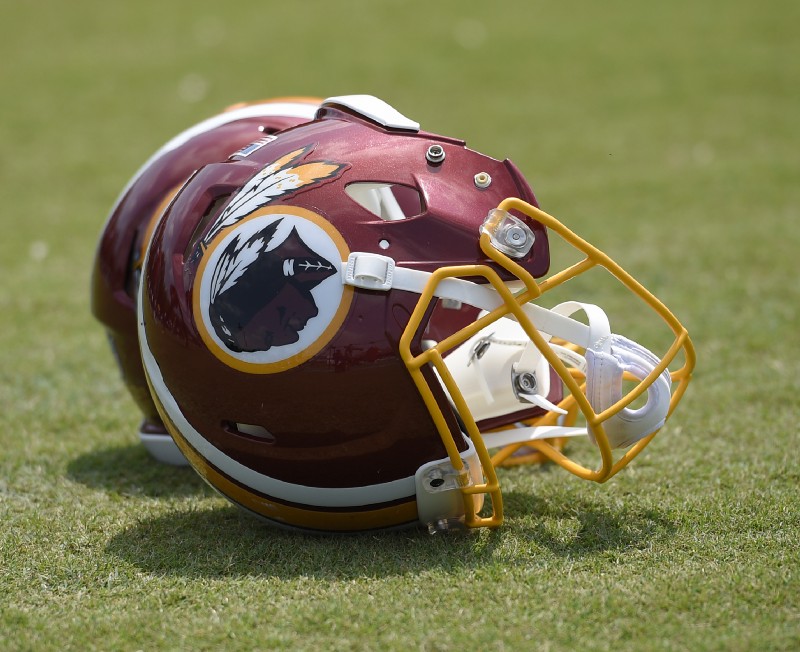 Washington Redskins football helmets are seen on the field during an NFL football team practice, Wednesday, June 14, 2017, in Ashburn, Va. CREDIT: AP Photo/Nick Wass