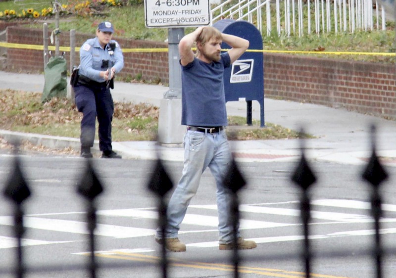 Edgar Welch, seen here surrendering to police in December, was inspired to go shoot up a D.C. pizza restaurant by right-wing fever-swamp figures close to the Trump movement who insisted that prominent Democrats are running a child sex trafficking ring. CREDIT: Sathi Soma via AP
