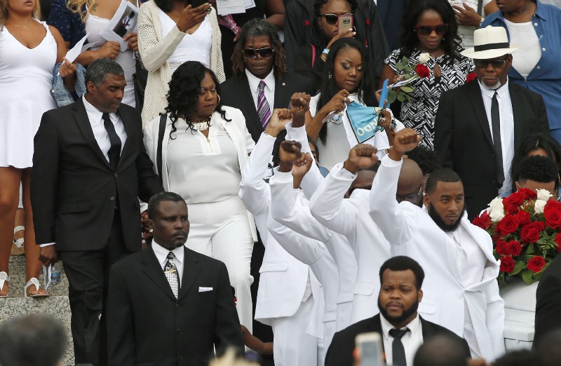 Valerie Castile, second from left, marches alongside the casket of her son Philando during his funeral last summer. CREDIT: AP Photo/Jim Mone