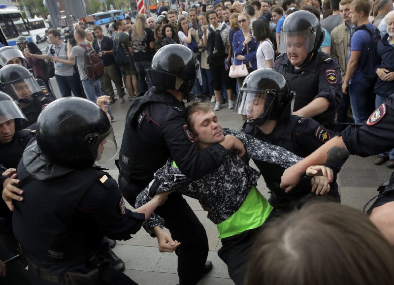 Police detain a protester during a demonstration in downtown Moscow, Russia, Monday, June 12, 2017. CREDIT: AP Photo/Pavel Golovkin