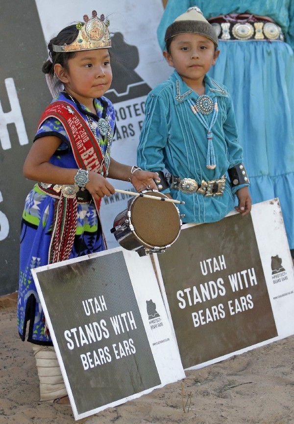 Children hold signs during a gathering of tribal leaders in Utah on June 10, 2017 to show support for the Bears Ears monument. CREDIT: AP Photo/Rick Bowmer