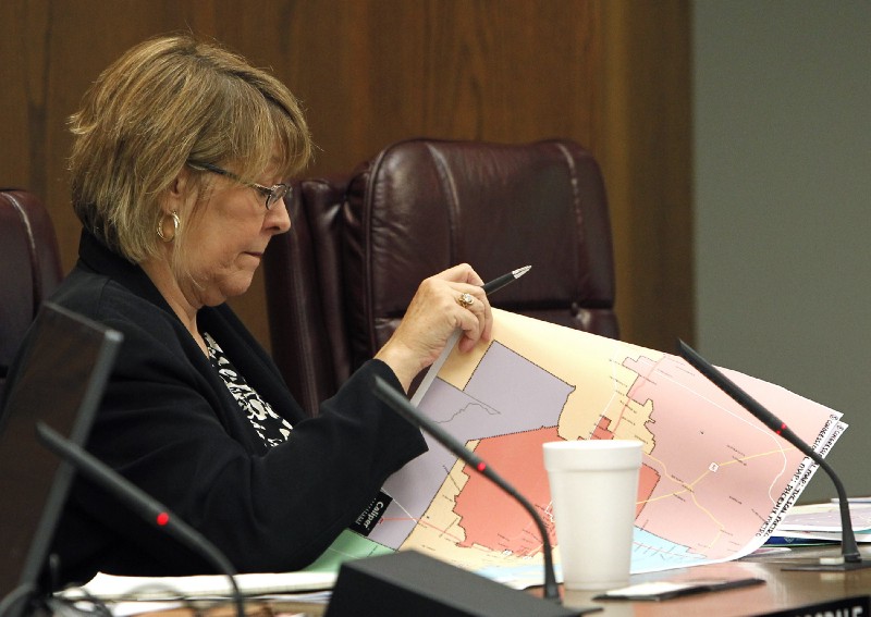A lawmaker looks at legislative redistricting maps. CREDIT: AP Photo/Ross D. Franklin