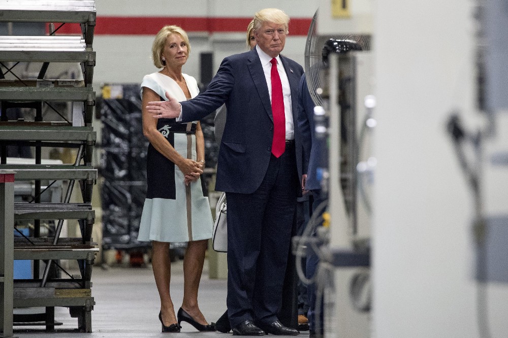 Education Secretary Betsy DeVos with President Donald Trump in Wisconsin on Tuesday. CREDIT: AP Photo/Andrew Harnik