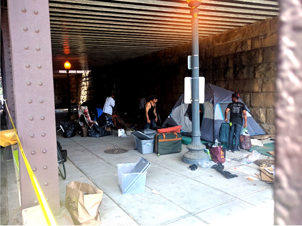 Homeless Washington, D.C. residents pack up their tents during a city clean-up on Tuesday, June 20. CREDIT: Alan Pyke/ThinkProgress