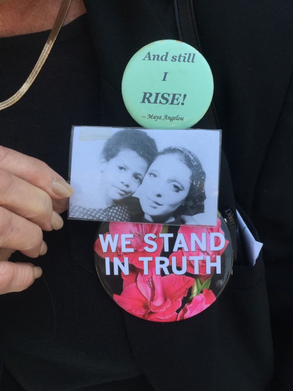 Victoria Valentino adjusts a photo of her with her six-year-old son, Tony, taken months before his death. The top lapel pin came in a birthday card from one of her daughters. CREDIT: Jessica Goldstein