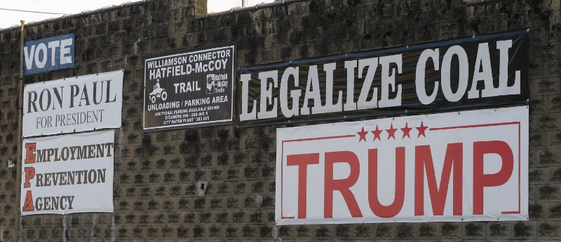 Political signs are posted on the wall of a building in Williamson , W.Va. in November. CREDIT: AP Photo/Steve Helber