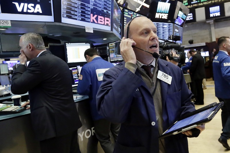 Trader Daniel Leporin, right, works on the floor of the New York Stock Exchange, May 17, 2017. CREDIT: AP/Richard Drew