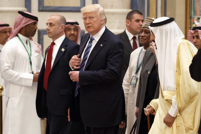 US President Donald Trump walks with Saudi King Salman, right, to attend the Arab Islamic American Summit, at the King Abdulaziz Conference Center, May 21, 2017, in Riyadh. (AP Photo/Evan Vucci)