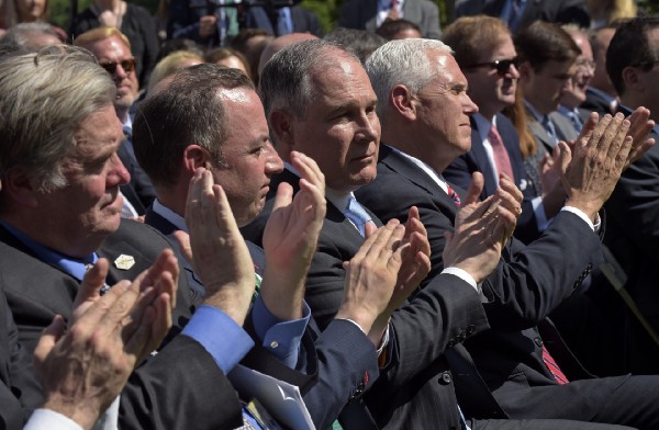 Administration officials applaud as President Donald Trump announces the U.S. will withdraw from the Paris climate accord. CREDIT: AP Photo/Susan Walsh