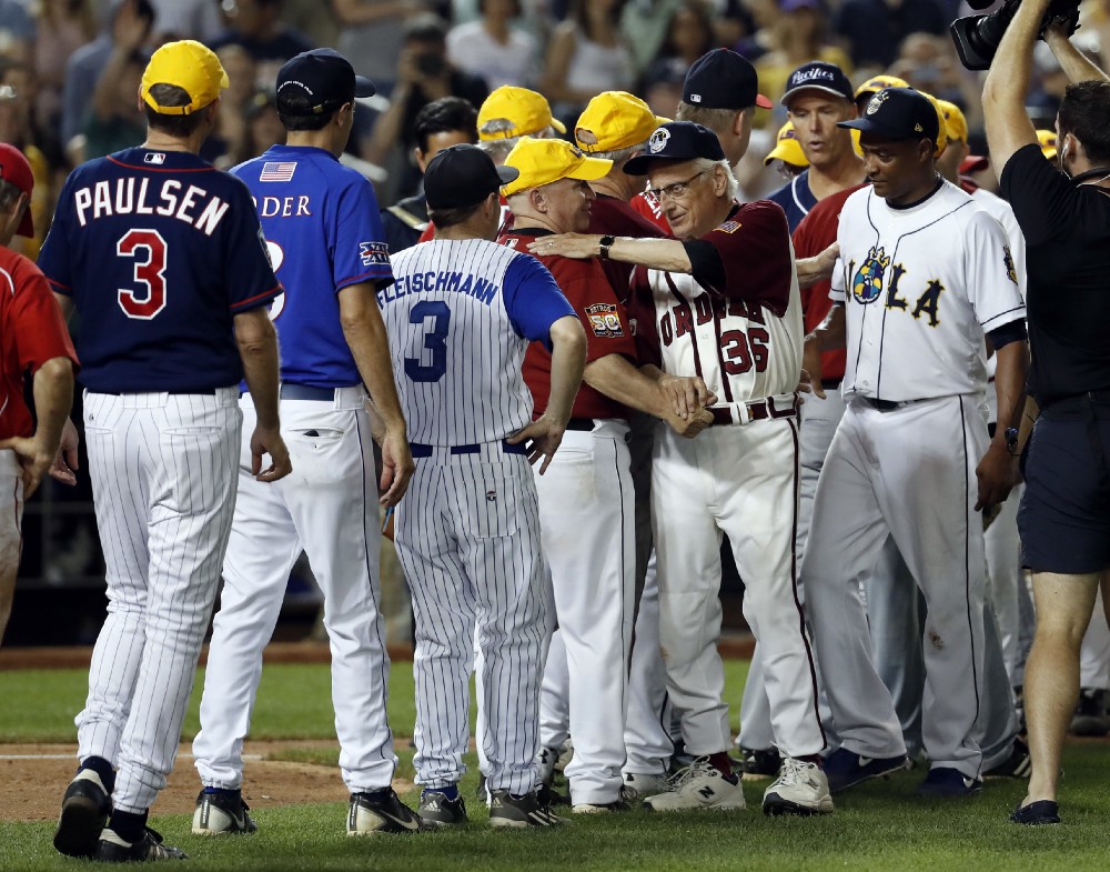 Rep. Bill Pascrell, D-N.J., (36) and Rep. Cedric Richmond, D-La., right, react with members of the Republican team after the Congressional baseball game, Thursday, June 15, 2017, in Washington. The annual GOP-Democrats baseball game raises money for charity. The democrats won 11–2. (AP Photo/Alex Brandon)