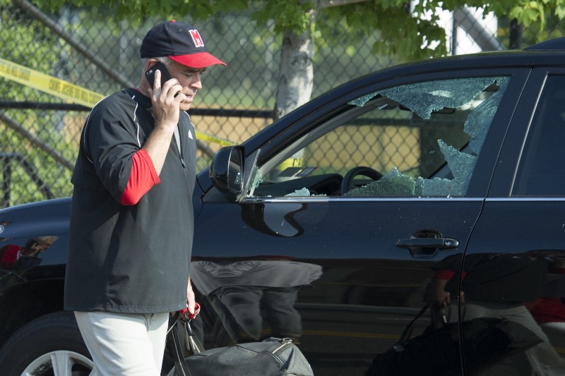 Rep. Brad Wenstrup, R-Ohio talks on the phone as he walks past a damaged vehicle in Alexandria, Va., Wednesday, June 14, 2017, after a shooting where House Majority Whip Steve Scalise of La., and others, were shot during a Congressional baseball practice. CREDIT: AP Photo/Cliff Owen