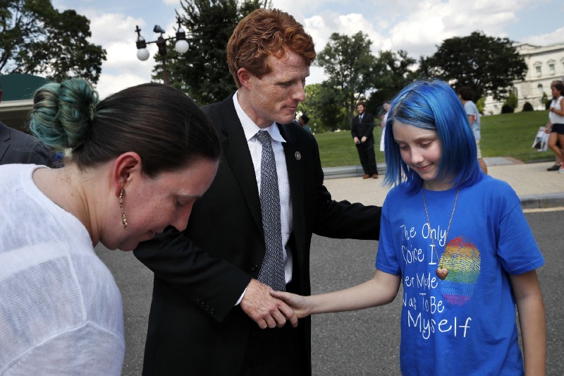 Rep. Joe Kennedy, D-Mass., center, shakes hands with an 11-year-old transgender girl who goes by the name Blue, whose parent is an airman at Ramstein Air Base, after Blue and her mother Jess Girven, left, attended Kennedy’s event in support of transgender members of the military, Wednesday, July 26, 2017, on Capitol Hill in Washington. CREDIT: AP Photo/Jacquelyn Martin