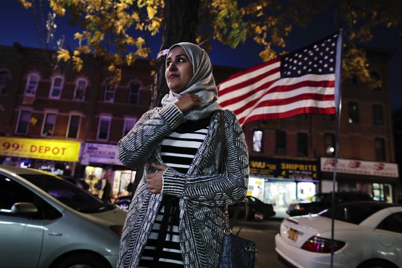 Enas Almadhwahi, an immigration outreach organizer for the Arab American Association of New York, stands for a photo along Fifth Avenue in the Bay Ridge neighborhood of Brooklyn, Friday, Nov. 11, 2016, in New York. CREDIT: AP Photo/Julie Jacobson