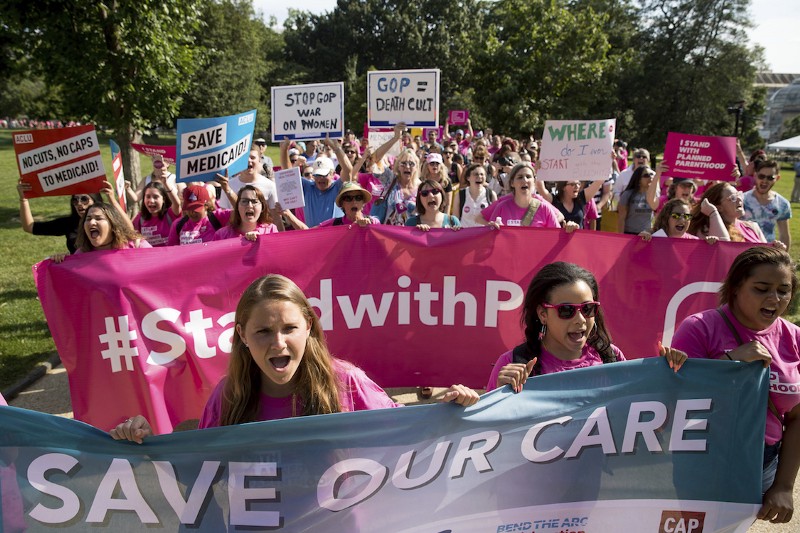 Demonstrators march around the Capitol Building as they protest against the Senate GOP healthcare bill in Washington, June 28, 2017. CREDIT: AP/Andrew Harnik