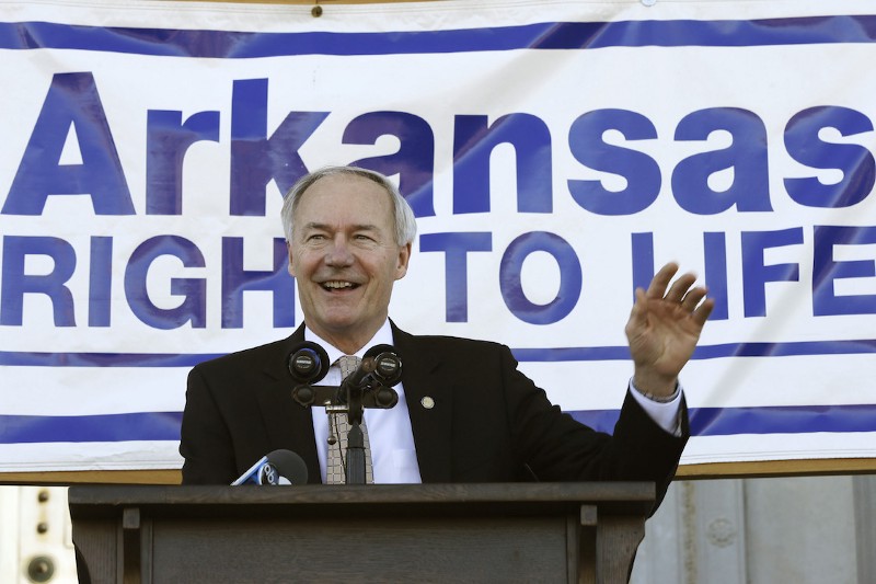 Arkansas Gov. Asa Hutchinson (R) waves before speaking at an anti-abortion rally at the Arkansas state Capitol in Little Rock, Ark., Jan. 18, 2015. CREDIT: AP/Danny Johnston