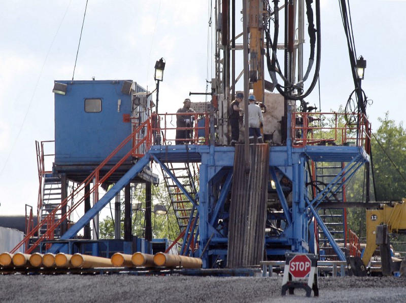 A crew works on a gas drilling rig at a well site. CREDIT: AP Photo/Keith Srakocic