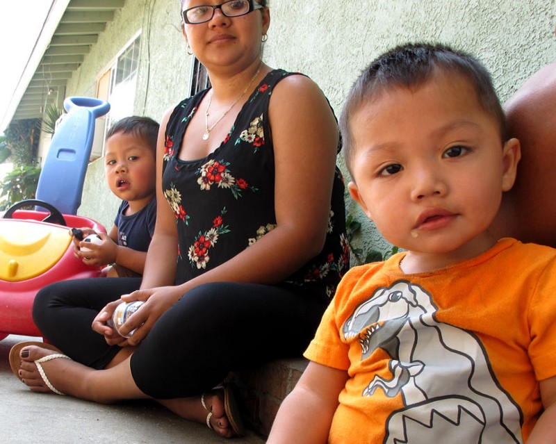 This Santa Ana mother’s children, ages 4, 2 and 1, are at the age when children are especially vulnerable if they ingest lead contaminated soil or inhale soil lead particles. Most of the tests conducted by ThinkProgress on Townsend Street where the family lives fall below the state level considered dangerous for children. CREDIT: Yvette Cabrera/ThinkProgress