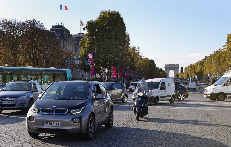 An electric BMW i3, foreground left, near the Champs Elysees in Paris. CREDIT: AP Photo/Francois Mori