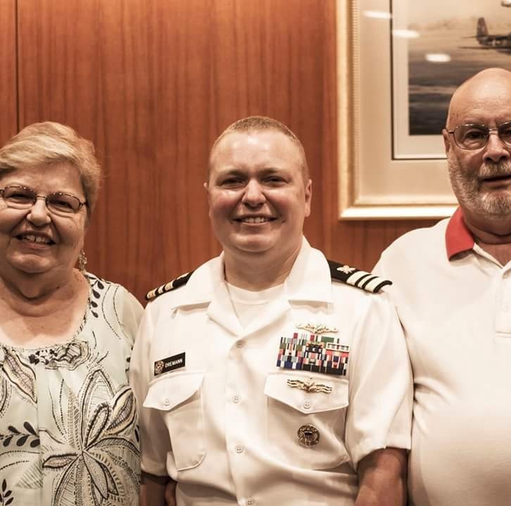 Lieutenant Commander Blake Dremann with his parents. CREDIT: Facebook/Blake Dremann