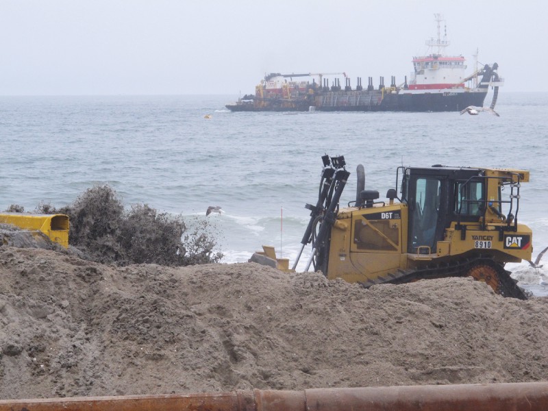 Sand pumped from an offshore ship flows from a pipe on the beach in the Ortley Beach section of Toms River, New Jersey, one of the hardest-hit spots by Superstorm Sandy. CREDIT: AP Photo/Wayne Parry