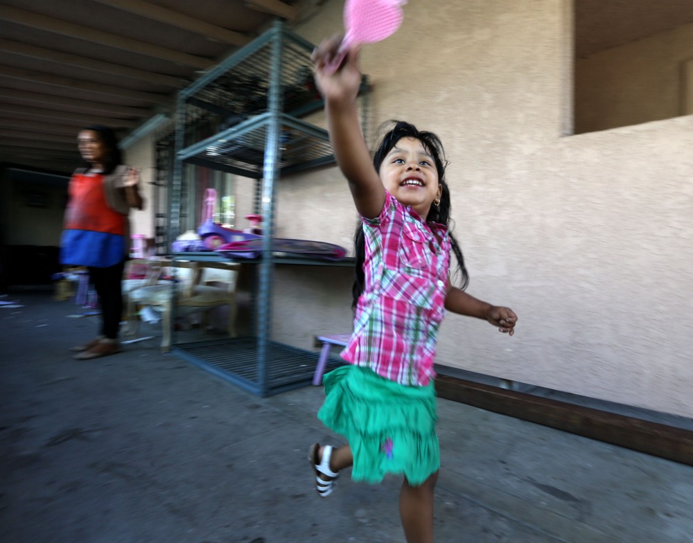 A 2-year-old girl runs carefree in her northwest Santa Ana home where ThinkProgress found dangerous levels of lead in the yard’s soil. CREDIT: Daniel A. Anderson for ThinkProgress