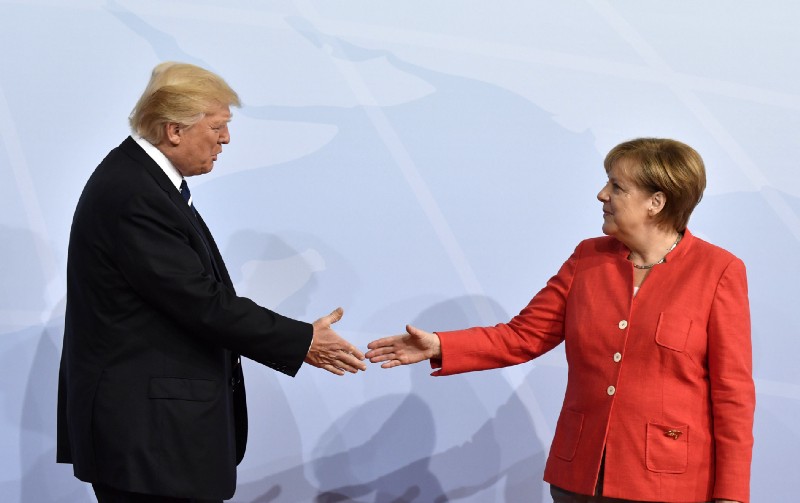 Trump and Merkel get a do-over. CREDIT: John MacDougall/Pool Photo via AP