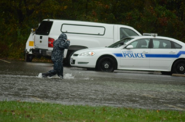 A sailor walks through parking lot during Hurricane Sandy at the Naval Air Station Oceana in Virginia Beach, Virginia, on Oct. 29, 2012 CREDIT: U.S. Navy/ Mass Communication Specialist 3rd Class Antonio P. Turretto Ramos