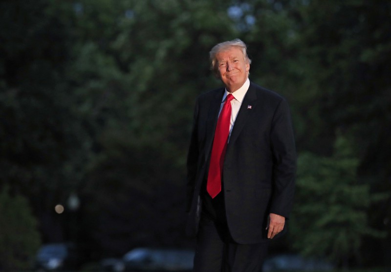 President Donald Trump smiles as he walks on the South Lawn upon arrival the White House in Washington, Saturday, July 8, 2017, from the G20 Summit in Hamburg, Germany. CREDIT: AP Photo/Manuel Balce Ceneta