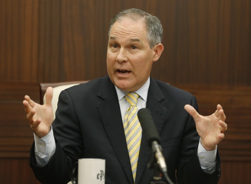 Then-Oklahoma Attorney General Scott Pruitt gestures as he answers a question during a news conference in 2013. CREDIT: AP Photo/Sue Ogrocki
