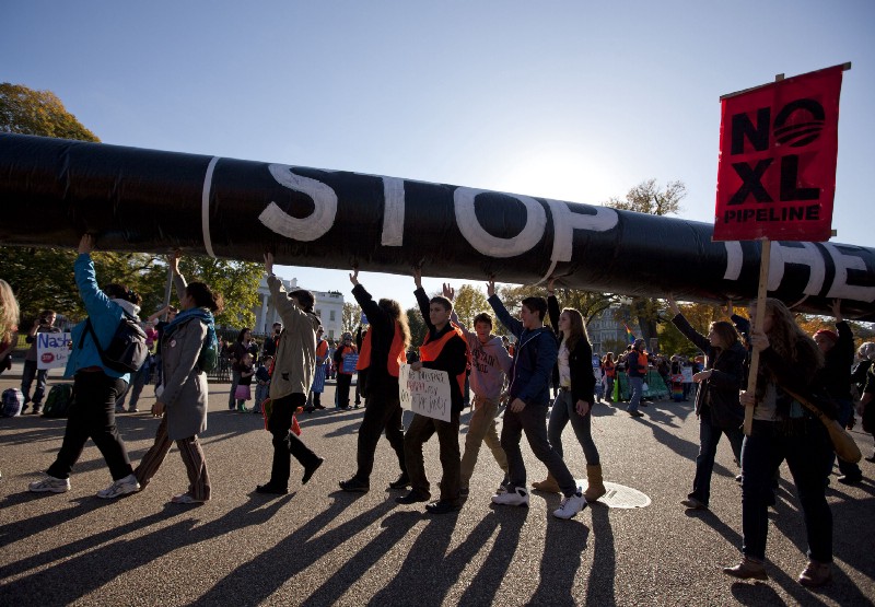 Demonstrators march against the Keystone XL Pipeline outside the White House. CREDIT: AP Photo/Evan Vucci