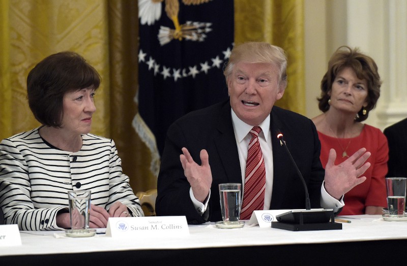 Sen. Susan Collins, R-Maine, left, and Sen. Lisa Murkowski, R-Alaska, right, listen to the president speak in June. CREDIT: AP/Susan Wlash