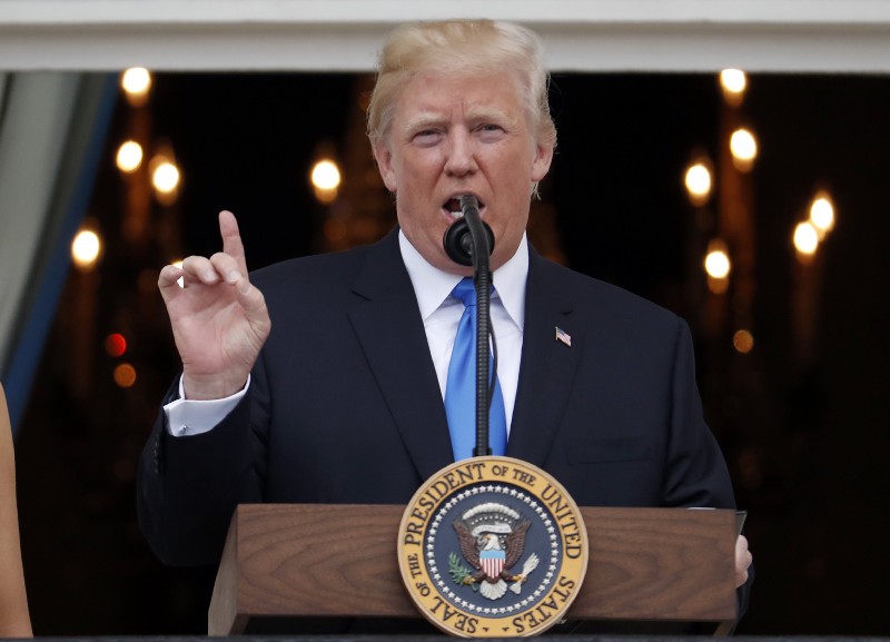 President Donald Trump speaks from the Truman Balcony at the Fourth of July picnic for military families on the South Lawn of the White House, Tuesday, July 4, 2017, in Washington. CREDIT: AP Photo/Alex Brandon