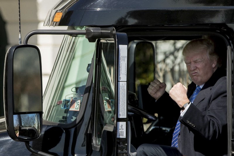 DAY 63 — in this March 23, 2017, file photo, President Donald Trump gestures while sitting in an 18-wheeler truck while meeting with truckers and CEOs regarding healthcare on the South Lawn of the White House in Washington. CREDIT: AP Photo/Andrew Harnik, File