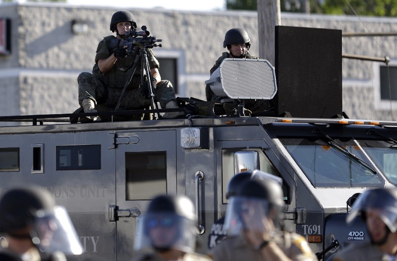 Police in a U.S. city, or soldiers occupying a foreign one? In Ferguson, MO, in 2014, it was often hard to tell. CREDIT: AP Photo/Jeff Roberson, File